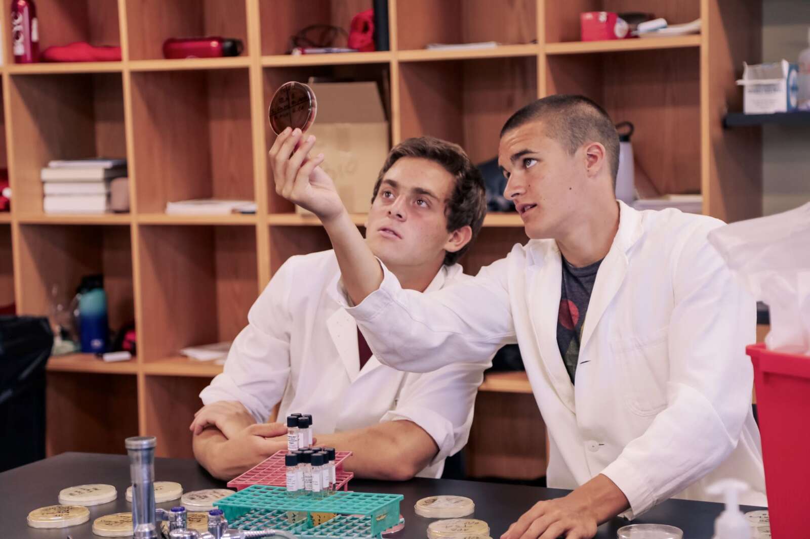 Two students looking at a petri dish
