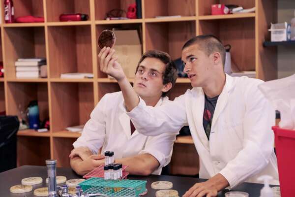 Two students looking at a petri dish