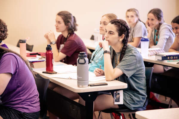 Students taking notes in a classroom