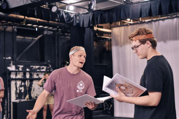 Two BCYC students acting with scripts