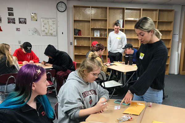 Students assist in a primary school setting