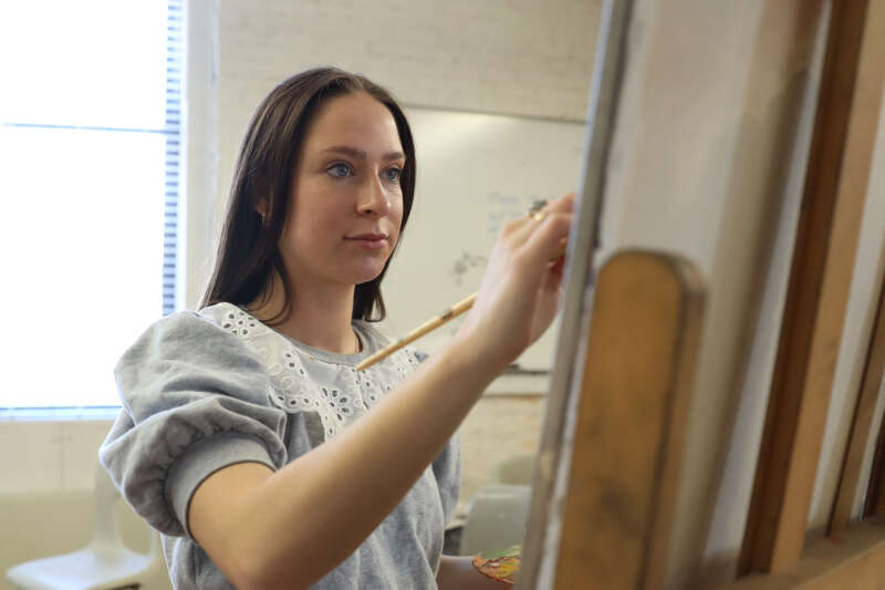 A student paints in art class