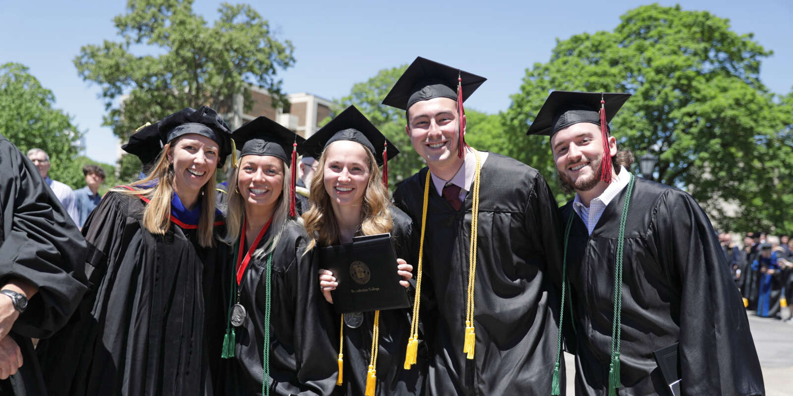 Graduates pose for a photo after Commencement