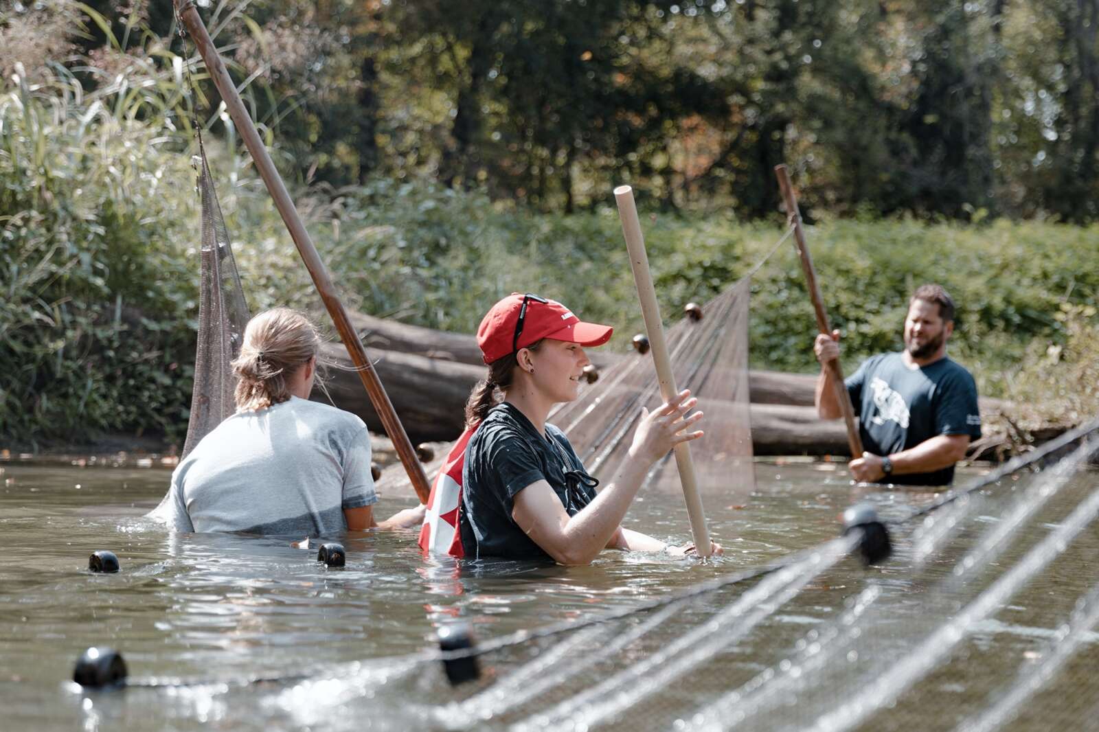 students in the river with nets