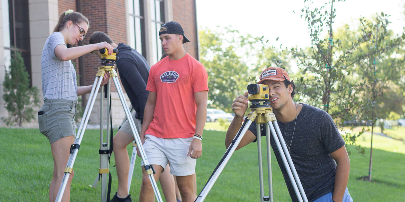 Several students looking through tripod cameras