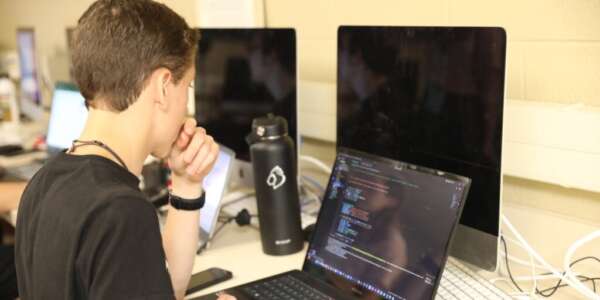 Student coding in the computer lab