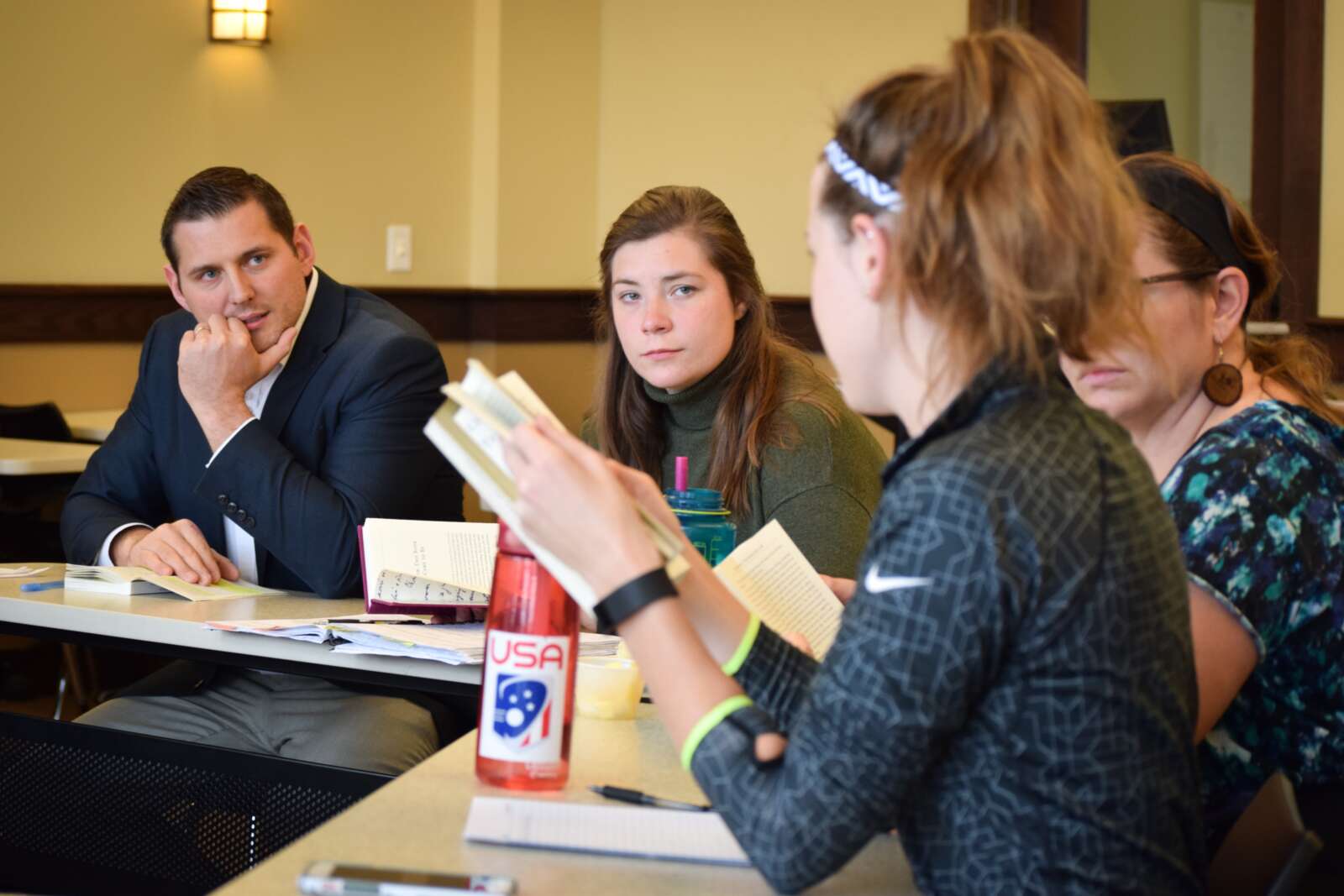 students and professor discussing readings in a circle