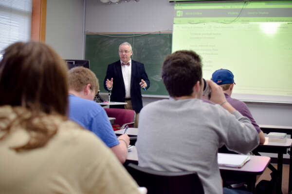 Dr Mulholland teaching with a projector