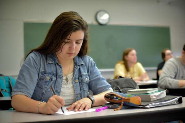 Student taking notes in class