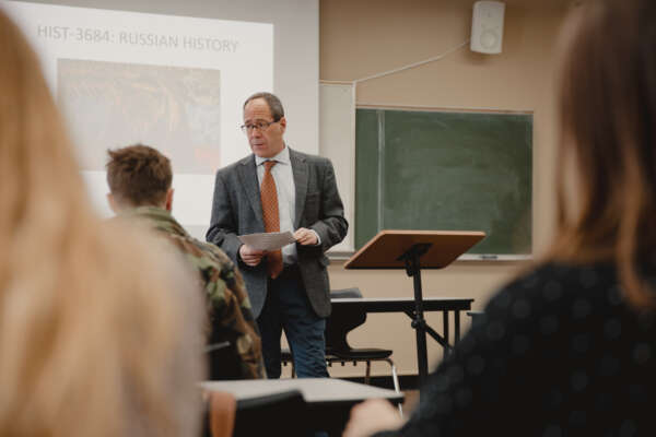 A professor teaches students in a history class