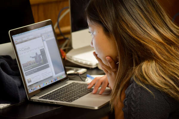 student working on the school newspaper