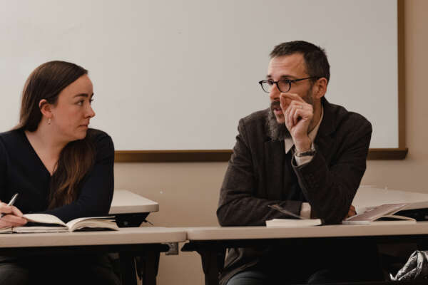 A teacher in a seminar class with a student
