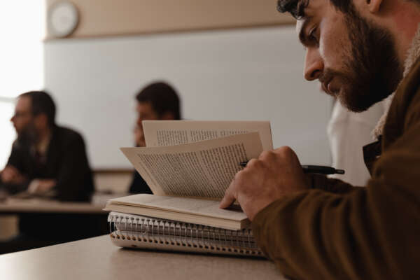 A student reads a book in a seminar class