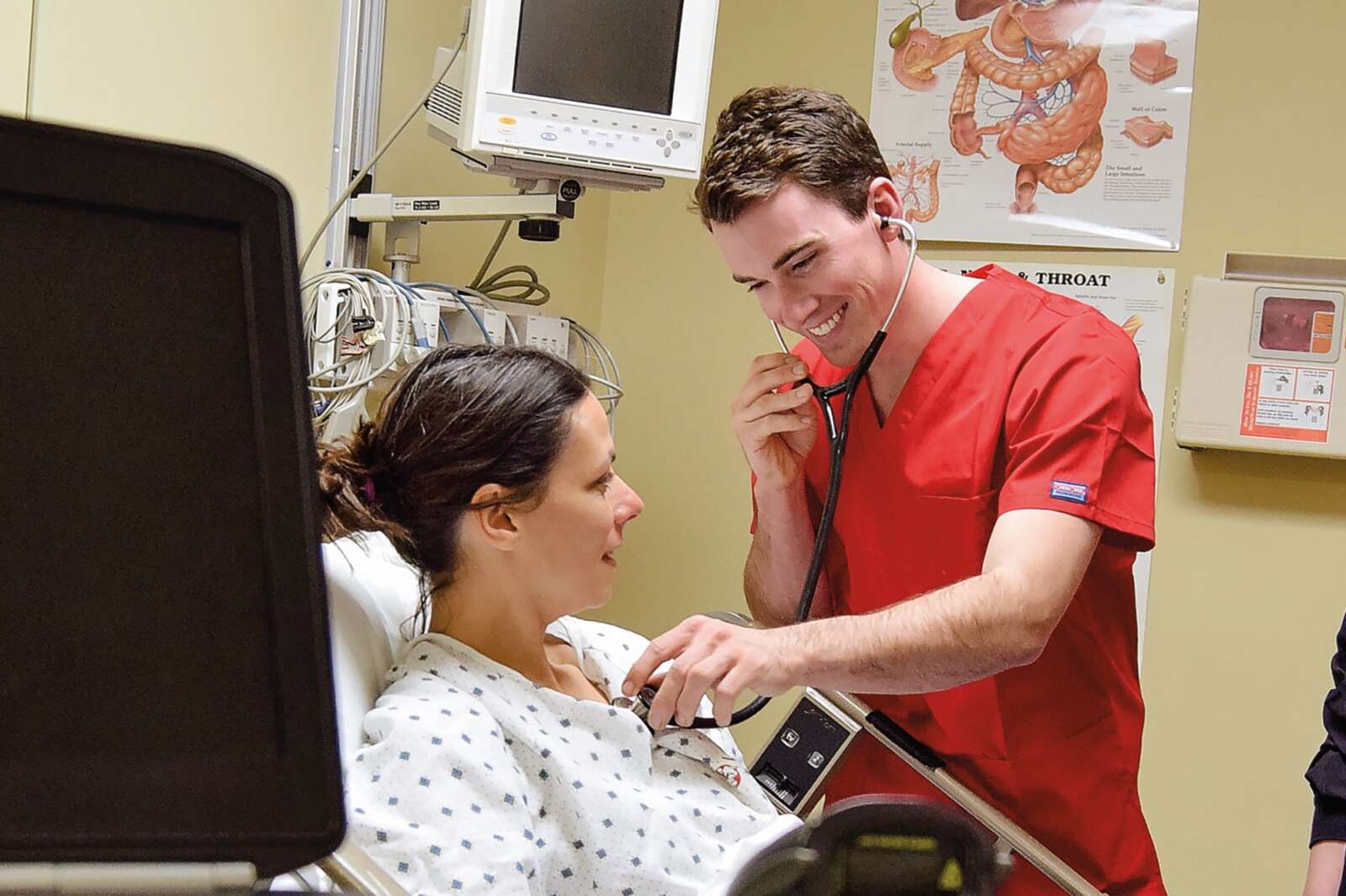 nursing students listening through a stethescope