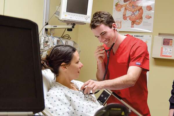 nursing students listening through a stethescope