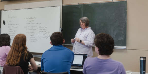 Dean Shankman teaching a Political Science class with a whiteboard