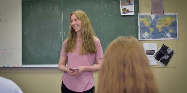 Dr. Sellers teaching by a chalkboard