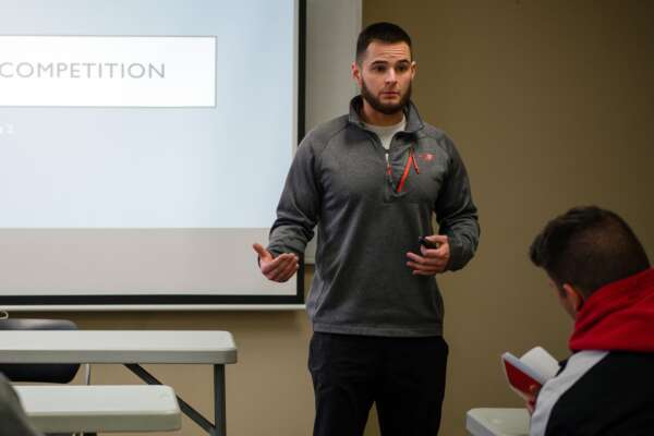 Person giving powerpoint on competition for exercise science