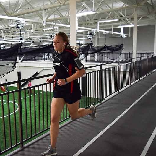 A student running on the Rec Center track