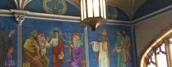 A wall mural depicting multiple historical and religious figures