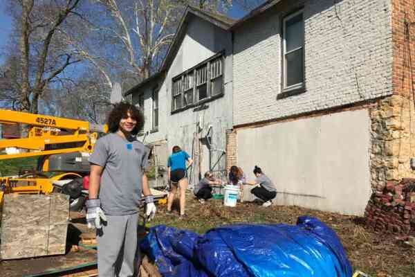 Students helping fix a house