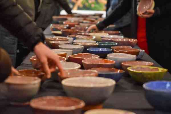 table filled with handmade pottery