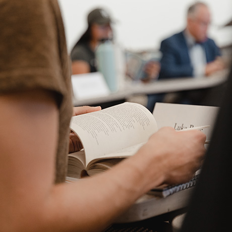 A student reads a book in a seminar class