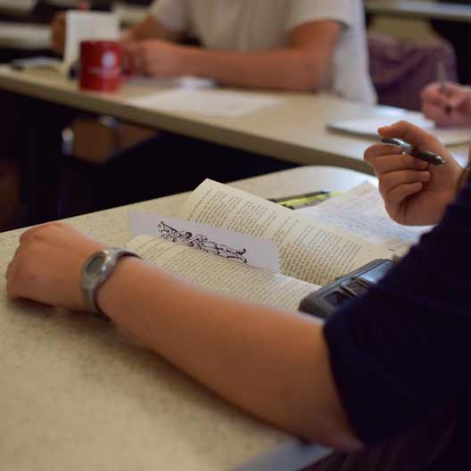 A student reading a book in class