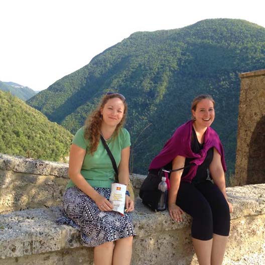 Benedictine students sitting on an old structure overlooking a beautiful landscape in Florence, Italy