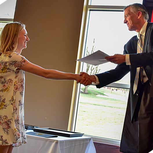 Head of the department giving a student an award