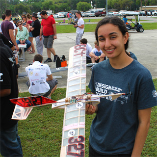 Student holding her self-made plane