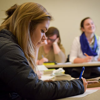 A student takes notes in class
