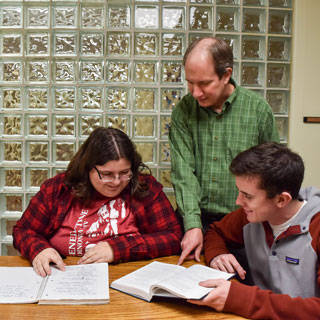 Dr. West helping students with homework