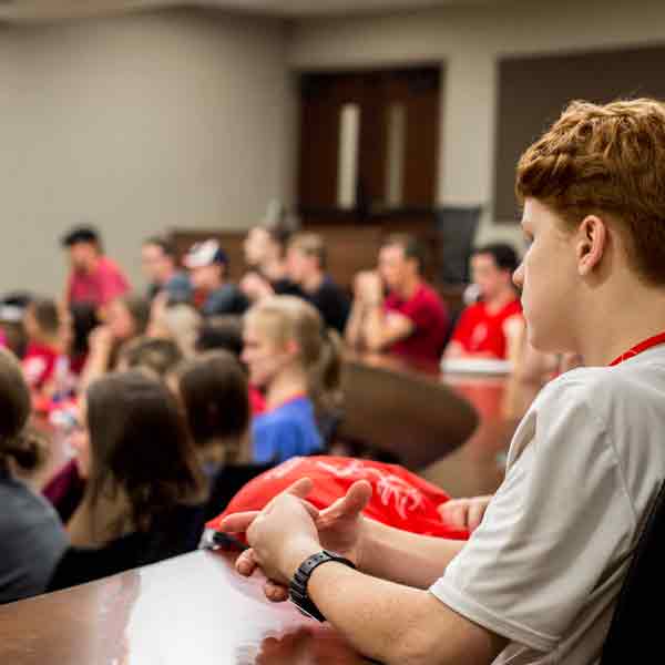 BCYC participants listen to a presentation in an auditorium