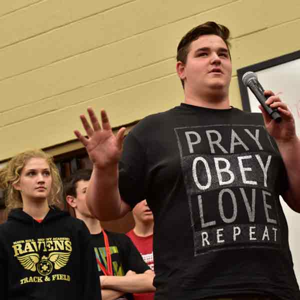 A BCYC participant speaks using a microphone