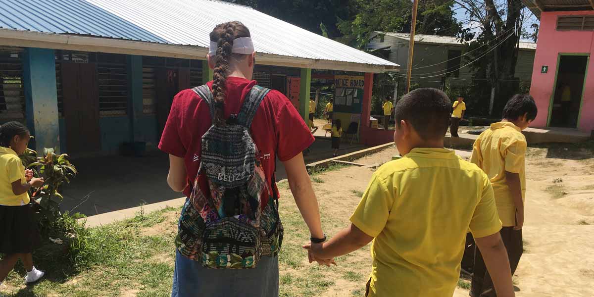 Student holding hands with a child