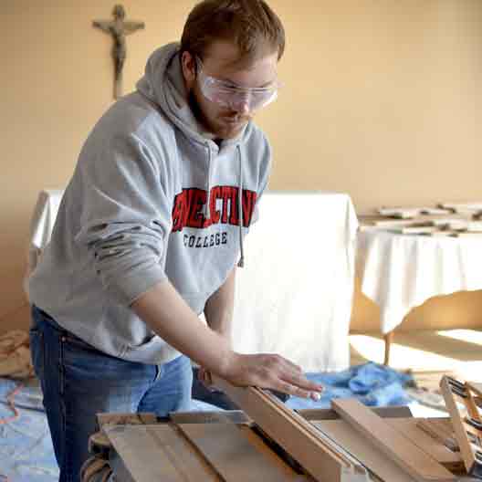 A student works at a table saw