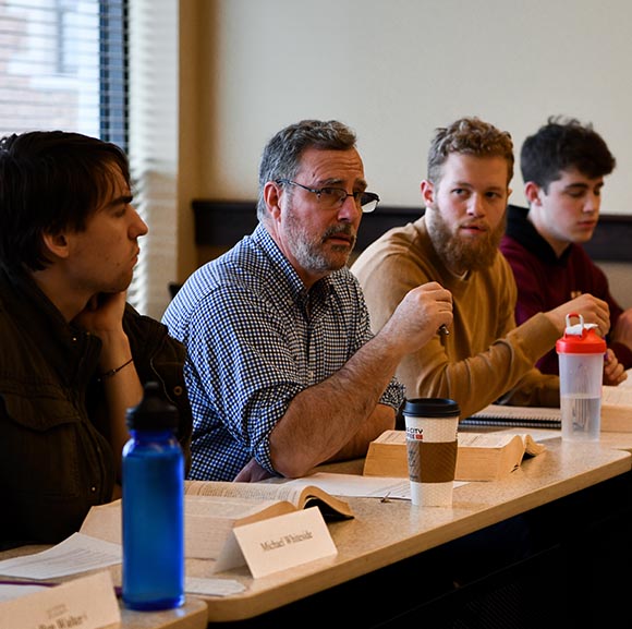 Dr. Jean Rioux with students in a seminar class